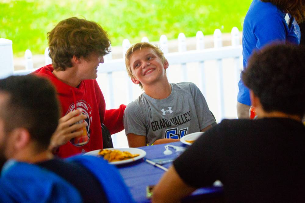 Boys at table laughing at Comerica Park event